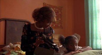 Movie still from “Crooklyn” (1994), directed by Spike Lee – An older woman holding a pair of scissors; Close Up shot, Low angle