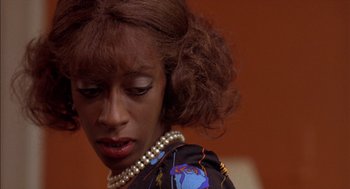 Movie still from “Crooklyn” (1994), directed by Spike Lee – A person wearing a necklace; Close Up shot, Low angle