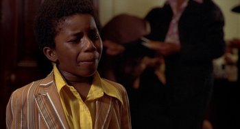Movie still from “Crooklyn” (1994), directed by Spike Lee – A woman in a yellow shirt is crying in a room; Close Up shot, Low angle