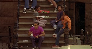 Movie still from “Crooklyn” (1994), directed by Spike Lee – A group of people sitting on some steps; Wide shot, High angle