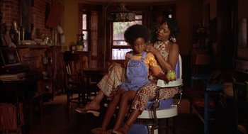 Movie still from “Crooklyn” (1994), directed by Spike Lee – A woman and a child sitting in a chair; Medium shot, Low angle