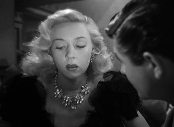 Movie still from “Crossfire” (1947), directed by Edward Dmytryk – A woman in a black dress is looking at another woman in a black dress; Close Up shot, Over the shoulder angle