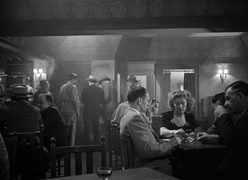 Movie still from “Crossfire” (1947), directed by Edward Dmytryk – A group of people sitting at a table in a room; Wide shot, High angle