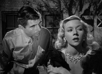 Movie still from “Crossfire” (1947), directed by Edward Dmytryk – A man and a woman are standing together; Close Up shot, Low angle