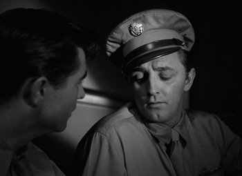Movie still from “Crossfire” (1947), directed by Edward Dmytryk – A man in a uniform and a man in a hat; Close Up shot, Over the shoulder angle