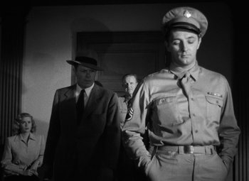 Movie still from “Crossfire” (1947), directed by Edward Dmytryk – Two men in suits and a man in a hat; Medium shot, Low angle