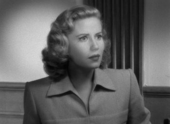 Movie still from “Crossfire” (1947), directed by Edward Dmytryk – An old black and white photo of a woman; Close Up shot, High angle