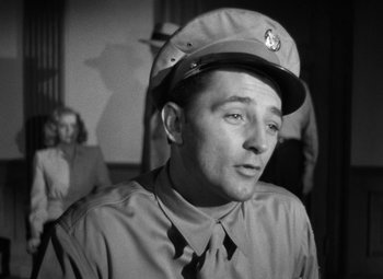 Movie still from “Crossfire” (1947), directed by Edward Dmytryk – A man wearing a hat and a tie; Close Up shot, Low angle