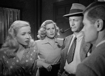 Movie still from “Crossfire” (1947), directed by Edward Dmytryk – A group of people standing next to each other in a room; Medium shot, High angle