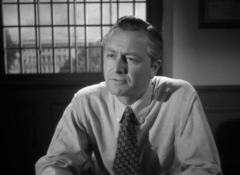 Movie still from “Crossfire” (1947), directed by Edward Dmytryk – An older man in a dress shirt and tie; Close Up shot, Low angle