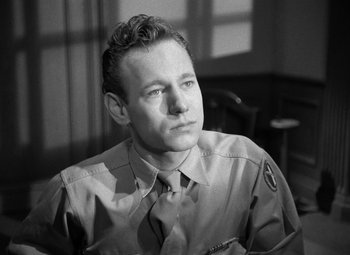 Movie still from “Crossfire” (1947), directed by Edward Dmytryk – A man wearing a uniform and a tie; Close Up shot, High angle