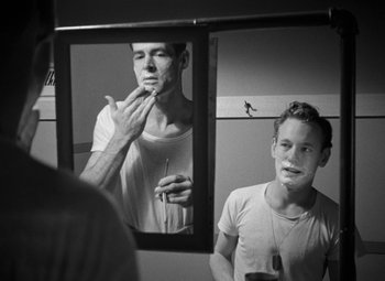 Movie still from “Crossfire” (1947), directed by Edward Dmytryk – A man is looking at himself in the mirror; Close Up shot, Over the shoulder angle