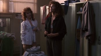 Movie still from “Crossing Delancey” (1988), directed by Joan Micklin Silver – Two women standing next to each other in front of lockers; Medium shot, Over the shoulder angle