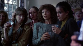 Movie still from “Crossing Delancey” (1988), directed by Joan Micklin Silver – A group of women standing next to each other holding drinks; Medium shot, Low angle
