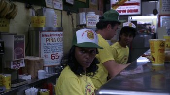 Movie still from “Crossing Delancey” (1988), directed by Joan Micklin Silver – A group of men and women wearing yellow shirts and green hats; Medium shot, High angle