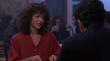 Movie still from “Crossing Delancey” (1988), directed by Joan Micklin Silver – A woman in a red shirt talking to a man in a black suit; Medium shot, Over the shoulder angle