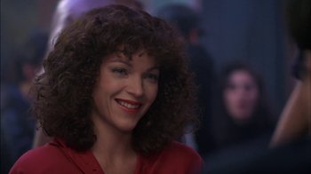Movie still from “Crossing Delancey” (1988), directed by Joan Micklin Silver – A person with curly hair smiling; Close Up shot, Low angle