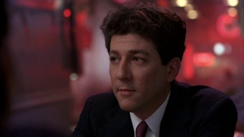 Movie still from “Crossing Delancey” (1988), directed by Joan Micklin Silver – A person wearing a suit and tie; Close Up shot, Low angle