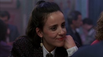 Movie still from “Crossing Delancey” (1988), directed by Joan Micklin Silver – A person wearing a suit and tie; Close Up shot, Over the shoulder angle