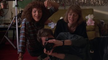 Movie still from “Crossing Delancey” (1988), directed by Joan Micklin Silver – A group of people sitting around each other; Medium shot, Low angle