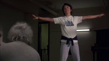 Movie still from “Crossing Delancey” (1988), directed by Joan Micklin Silver – A woman standing in front of an older person; Medium shot, Low angle