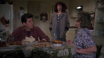 Movie still from “Crossing Delancey” (1988), directed by Joan Micklin Silver – A group of people sitting at a table with food; Medium shot, High angle
