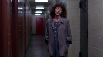 Movie still from “Crossing Delancey” (1988), directed by Joan Micklin Silver – A woman standing in a hallway with her hands in her pockets; Medium shot, Low angle