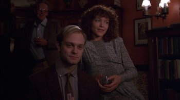Movie still from “Crossing Delancey” (1988), directed by Joan Micklin Silver – A man and a woman posing for a picture; Medium shot, Low angle