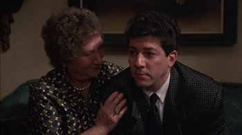 Movie still from “Crossing Delancey” (1988), directed by Joan Micklin Silver – An older woman and a younger man sitting next to each other; Close Up shot, Over the shoulder angle
