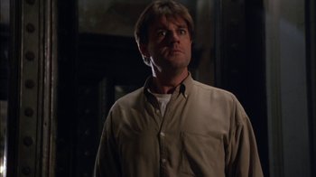 Movie still from “Crossing Delancey” (1988), directed by Joan Micklin Silver – A man standing in a dark room with his eyes wide open; Close Up shot, Low angle