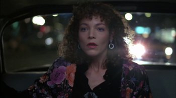 Movie still from “Crossing Delancey” (1988), directed by Joan Micklin Silver – A person in a car with lights in the background; Close Up shot, Over the shoulder angle