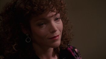 A person with curly brown hair