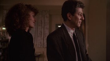 Movie still from “Crossing Delancey” (1988), directed by Joan Micklin Silver – A man and a woman standing next to each other in a room; Medium shot, Over the shoulder angle