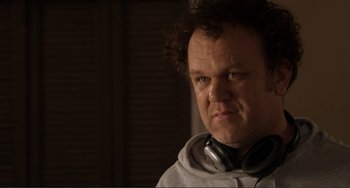 Movie still from “Cyrus” (2010), directed by Jay Duplass – A person wearing headphones and a hoodie; Close Up shot, Over the shoulder angle