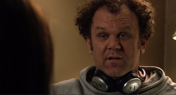 Movie still from “Cyrus” (2010), directed by Jay Duplass – A person wearing headphones; Close Up shot, Over the shoulder angle