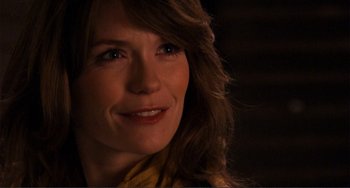 Movie still from “Cyrus” (2010), directed by Jay Duplass – A woman's face in a dark room; Close Up shot, Over the shoulder angle