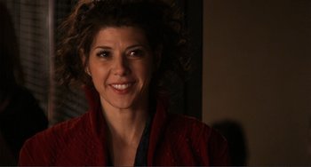 Movie still from “Cyrus” (2010), directed by Jay Duplass – A person wearing a red sweater smiling; Close Up shot, Over the shoulder angle