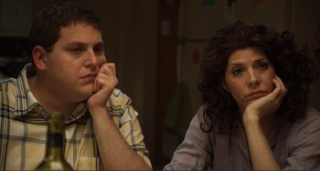 Movie still from “Cyrus” (2010), directed by Jay Duplass – A man and a woman sitting next to each other at a table; Close Up shot, Over the shoulder angle