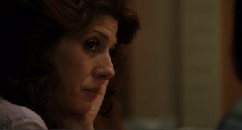 Movie still from “Cyrus” (2010), directed by Jay Duplass – A woman's face as she looks off to the side; Close Up shot, Over the shoulder angle