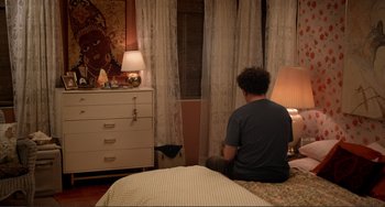 Movie still from “Cyrus” (2010), directed by Jay Duplass – A man sitting on a bed in front of a dresser; Wide shot, High angle
