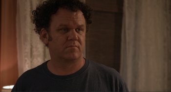 Movie still from “Cyrus” (2010), directed by Jay Duplass – A person wearing a t - shirt; Close Up shot, Over the shoulder angle