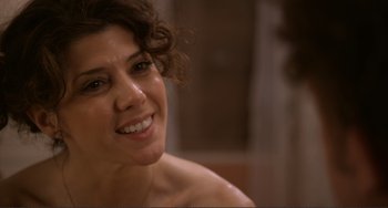 Movie still from “Cyrus” (2010), directed by Jay Duplass – A person with a smile on their face; Close Up shot, Over the shoulder angle