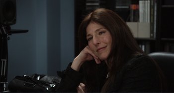 Movie still from “Cyrus” (2010), directed by Jay Duplass – A woman sitting in front of a camera with her hand under her chin; Close Up shot, Over the shoulder angle