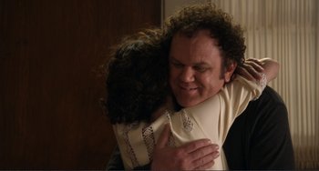 Movie still from “Cyrus” (2010), directed by Jay Duplass – A man hugging a woman in front of a door; Close Up shot, Over the shoulder angle