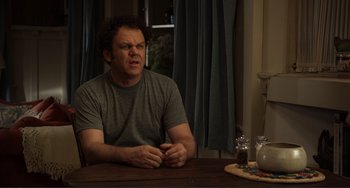 Movie still from “Cyrus” (2010), directed by Jay Duplass – A man sitting at a table in front of a window; Close Up shot, Low angle