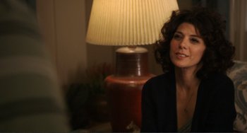 Movie still from “Cyrus” (2010), directed by Jay Duplass – A woman sitting in front of a lamp in a room; Close Up shot, Over the shoulder angle
