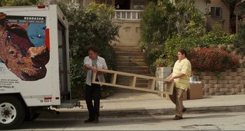 Movie still from “Cyrus” (2010), directed by Jay Duplass – Two men carrying a ladder down the street; Wide shot, High angle