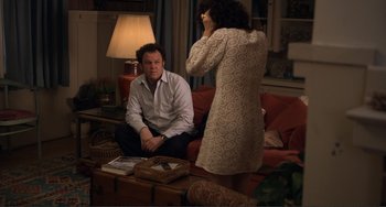 Movie still from “Cyrus” (2010), directed by Jay Duplass – A man and a woman sitting on a red couch; Medium shot, Over the shoulder angle