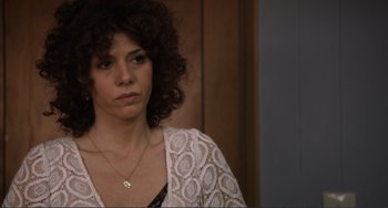 Movie still from “Cyrus” (2010), directed by Jay Duplass – A person with curly hair wearing a necklace; Close Up shot, Over the shoulder angle