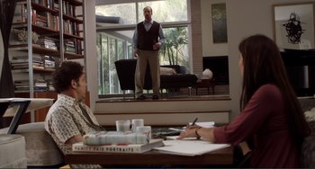 Movie still from “Cyrus” (2010), directed by Jay Duplass – A man standing in front of a living room window; Wide shot, Over the shoulder angle